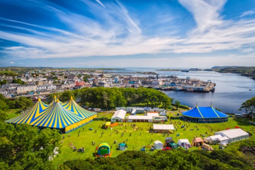 drone looking down on Heb Celt festival site with water and ferry terminal in the background.