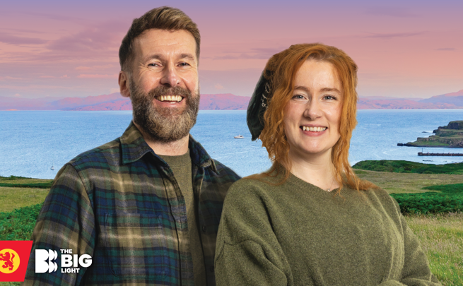 The Hebridean Baker and Nati Galloway standing outdoors with a scenic coastal landscape behind them.
